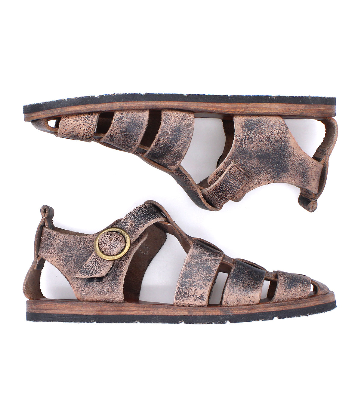 A side view of the Bed|Stü Lone sandals, featuring brown distressed leather with multiple straps, a prominent round antique brass buckle, and flat rubber soles with a contoured footbed.