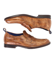 A pair of Bed|Stü Lumaro brown distressed leather penny loafers with dark soles, positioned side by side and viewed from the side against a white background.
