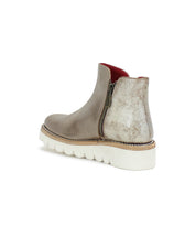 The Bed|Stü Lydyi ankle boot in taupe leather features a side zipper, white ridged platform outsole, and red interior lining, displayed from a rear angle.