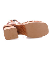 Bottom view of the Bed|Stü Lyxon sandal featuring a wooden block platform heel, open-toe styling, and a flat, textured rubber outsole.