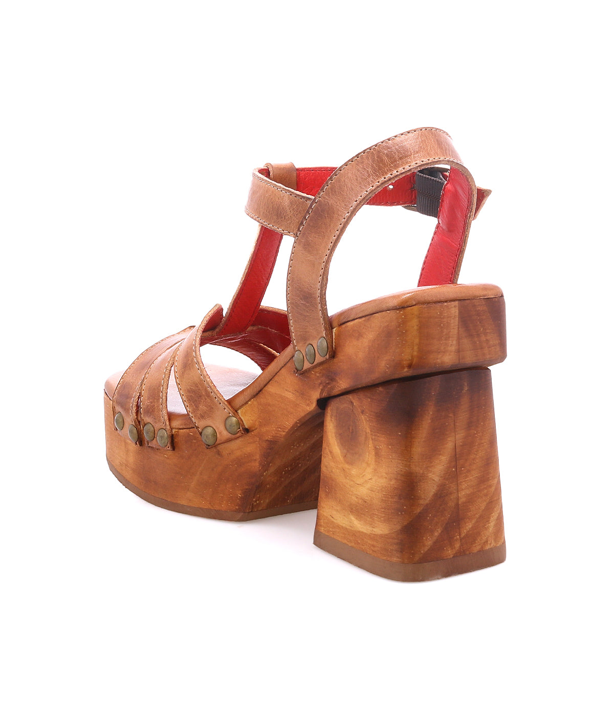 The Lyxon sandal by Bed|Stü is a brown wooden platform heel with a thick heel, open toe, T-strap design, red interior straps, and metal rivet accents, displayed against a white background.
