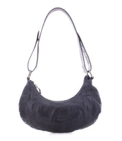 The Madre by Bed|Stü is a black leather hobo handbag featuring a single shoulder strap, rounded bottom, and subtle metal stud accents for a statement-making look. This edgy shoulder bag is shown against a white background.