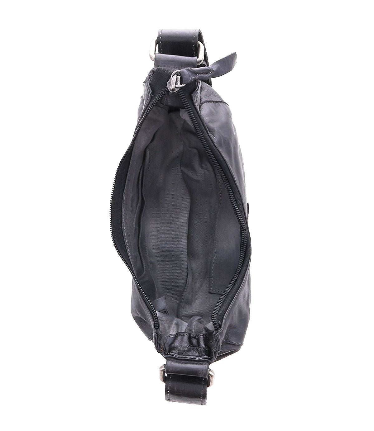 The Madre crossbody bag from Bed|Stü, shown open and empty with its zippered main compartment, is photographed from above against a white background—an edgy shoulder bag designed to make a statement.
