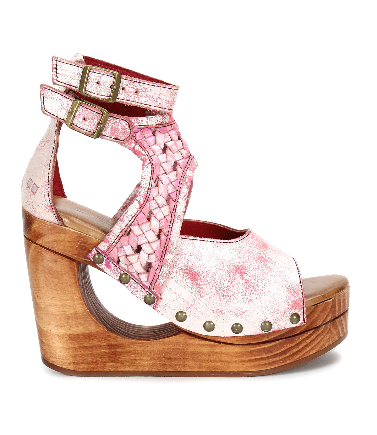 The Magic sandal by Bed|Stü features a handwoven pink and white leather upper, double ankle buckles, and a sculpted wooden platform heel accented with metal rivet details.