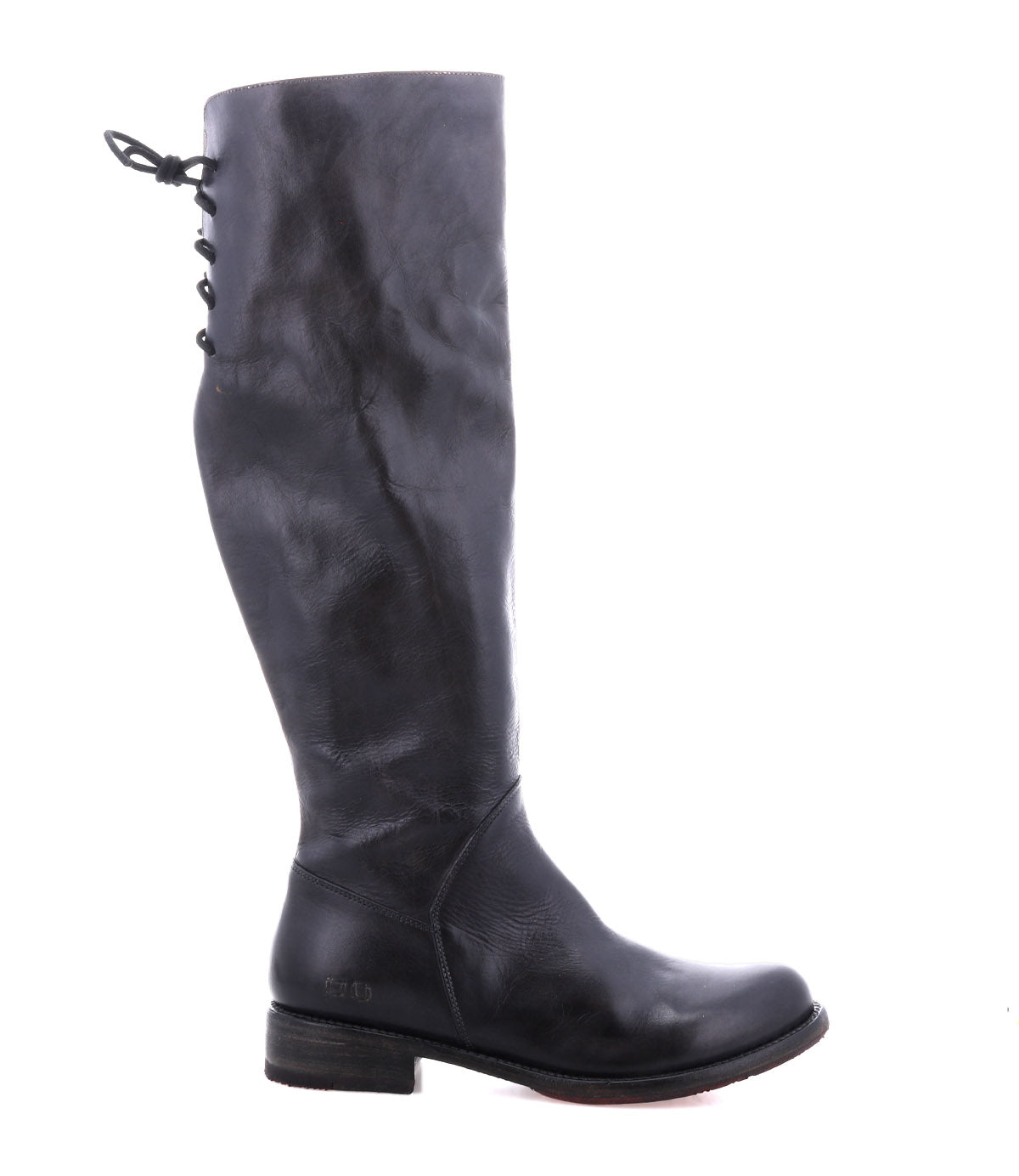 A single Manchester boot by Bed|Stü in black leather is shown in side profile against a white background, featuring a modern classic knee-high design with an elegant lace-up detail at the back upper shaft and a low, comfortable flat heel.