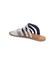The Bed|Stü Margin sandal features a tan sole and several metallic silver leather straps across the upper, displayed from a rear diagonal angle against a clean white background—a perfect choice to elevate your summer wardrobe.