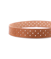 Bed|Stü's Mccoy is a brown leather belt featuring a supple leather strap with evenly spaced small round holes for customizable fit and a durable metal buckle, shown coiled in a circular shape on a white background.
