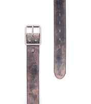 A close-up of the Bed|Stü Meander belt, crafted from distressed brown leather with an antique metal buckle and sturdy rivets, displayed flat against a white background.