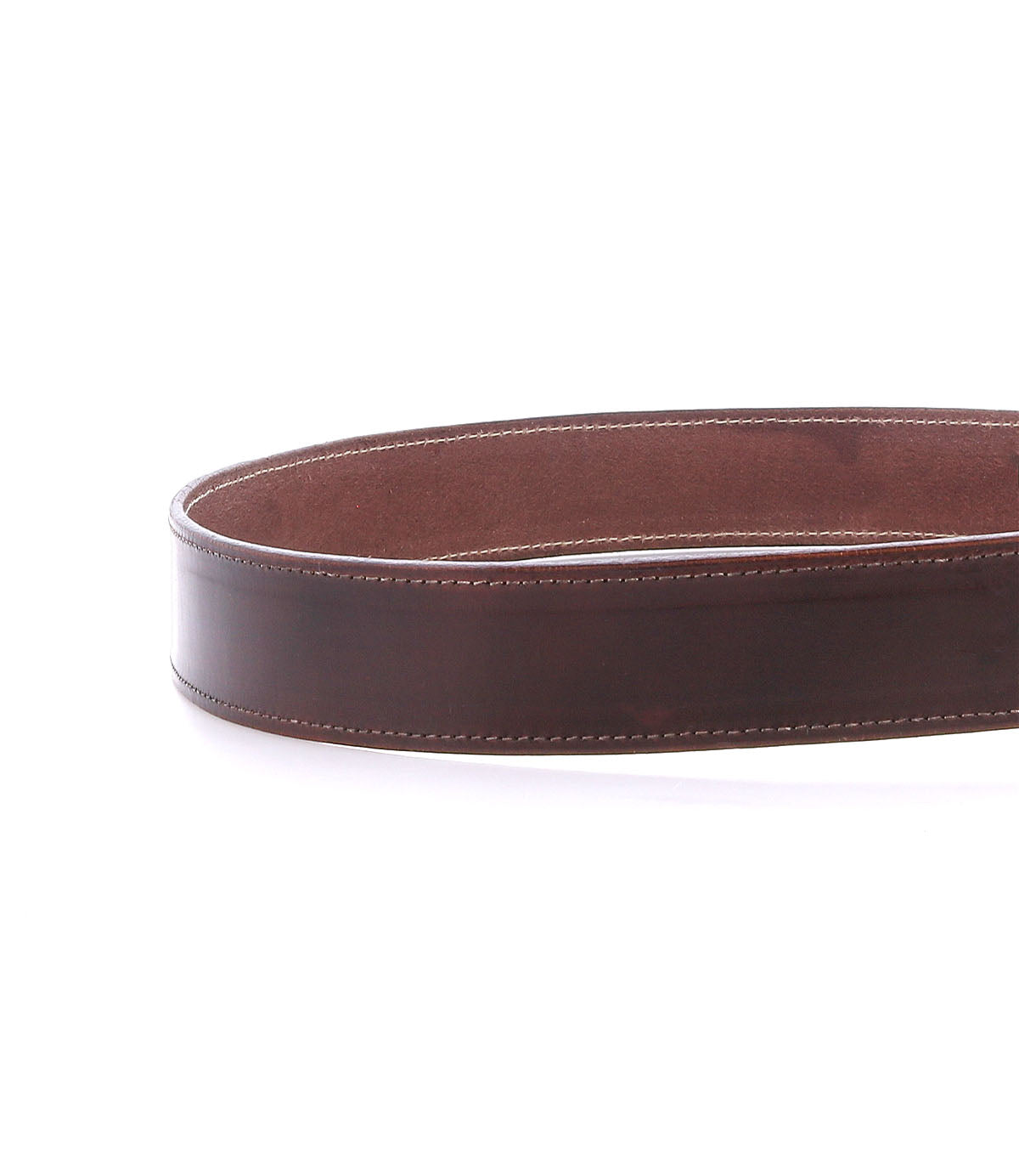 The Bed|Stü Meander is a brown distressed leather belt featuring visible white stitching and an antique metal buckle, shown coiled on a white background.