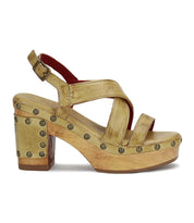 Bed|Stü "Mediation" tan platform heeled slingback sandal, featuring crisscross leather straps, metal stud accents along the sole, a chunky heel, cushioned insole for extra comfort, and an adjustable ankle buckle strap, displayed in side profile.