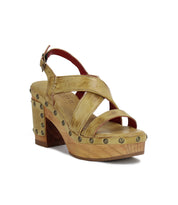 Introducing "Mediation" by Bed|Stü: a beige heeled slingback sandal with crisscross leather straps, cushioned insole for enhanced comfort, wooden platform sole, brass stud accents, and an adjustable ankle buckle.