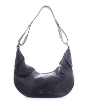 The Megara by Bed|Stü is a black leather hobo shoulder bag with an adjustable strap and minimal hardware, featuring refined leather details, displayed against a white background.