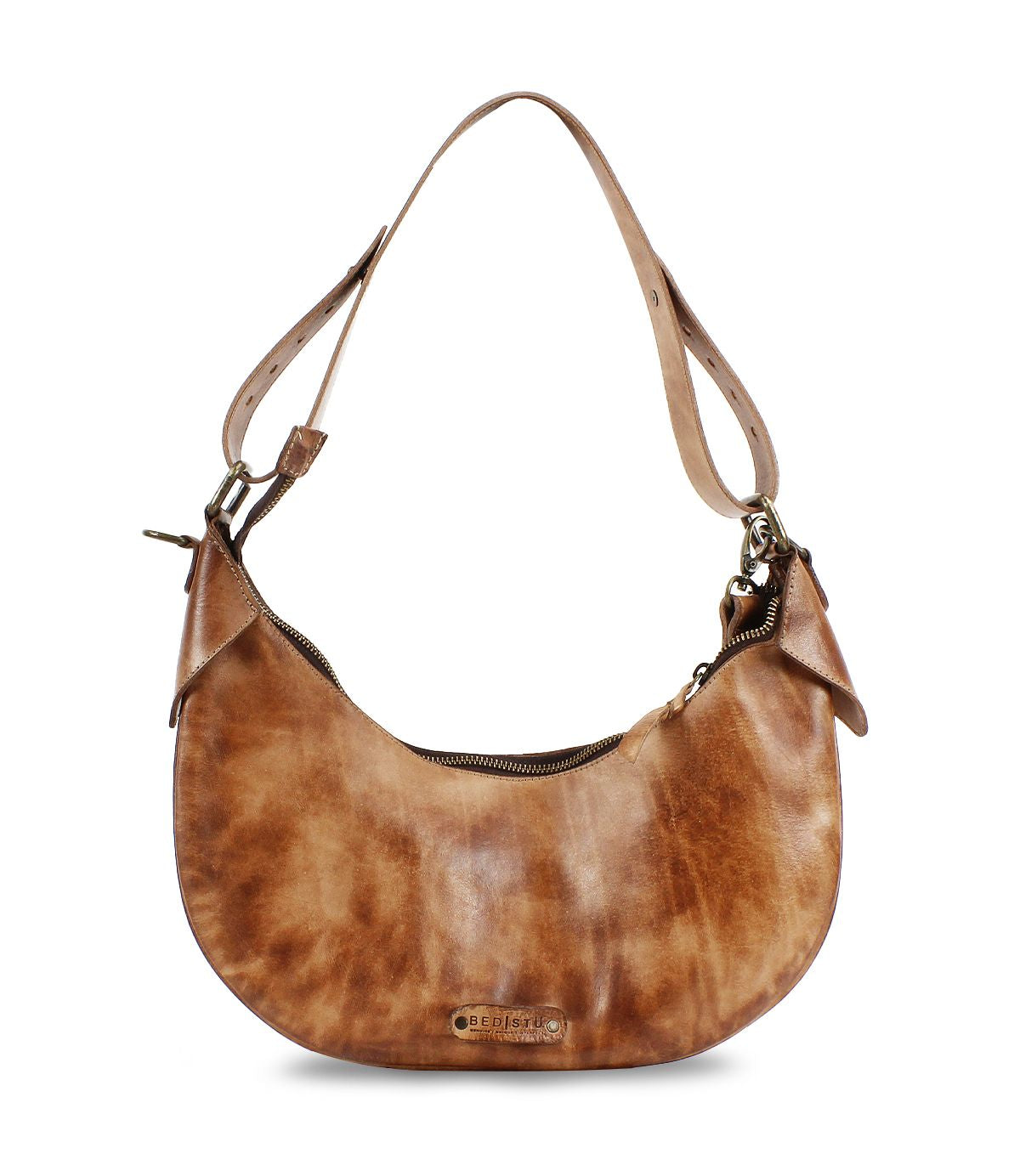 The Megara by Bed|Stü is a brown leather saddle bag with a curved shape, adjustable strap, and visible zipper closure, featuring refined leather details for a polished look.