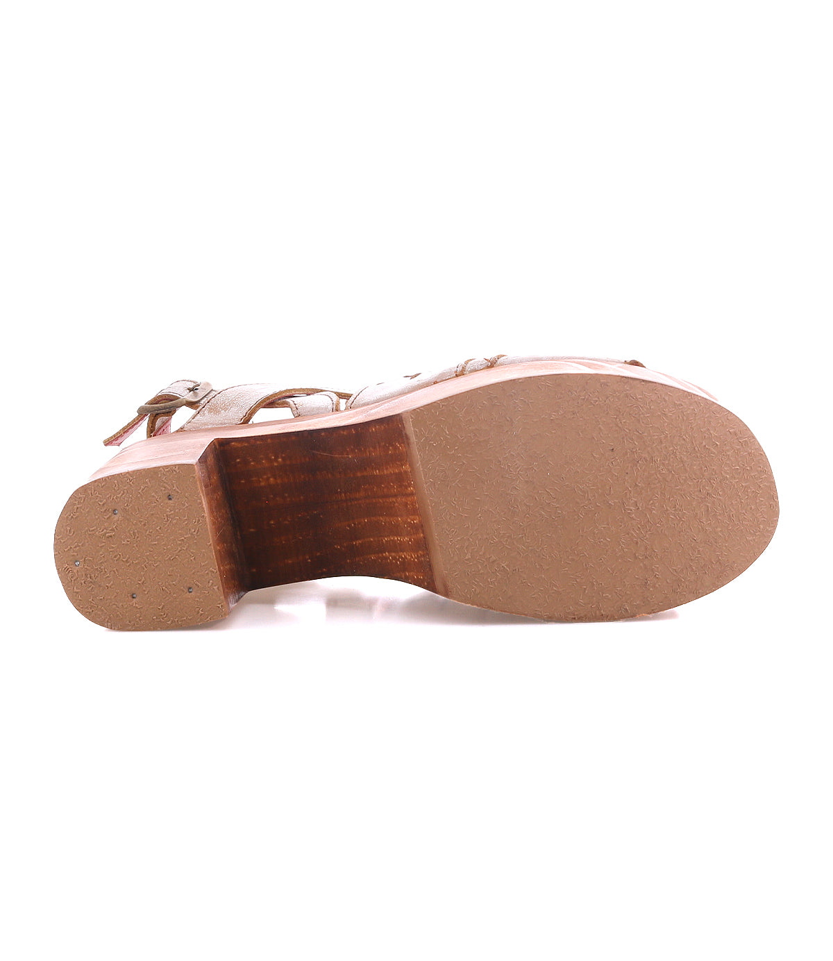 Bottom view of the Bed|Stü Melodramatic platform sandal featuring a wooden sole, tan rubber outsole, and visible upper straps. A chunky leather heel enhances its bold silhouette, with the sandal displayed sole-up against a white background.