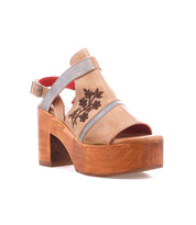 The Melodramatic sandal by Bed|Stü features gray embroidered leather straps, a tan platform with a thick chunky leather heel, an open toe, side embroidery detail, and a vibrant red inner lining, shown against a white background.