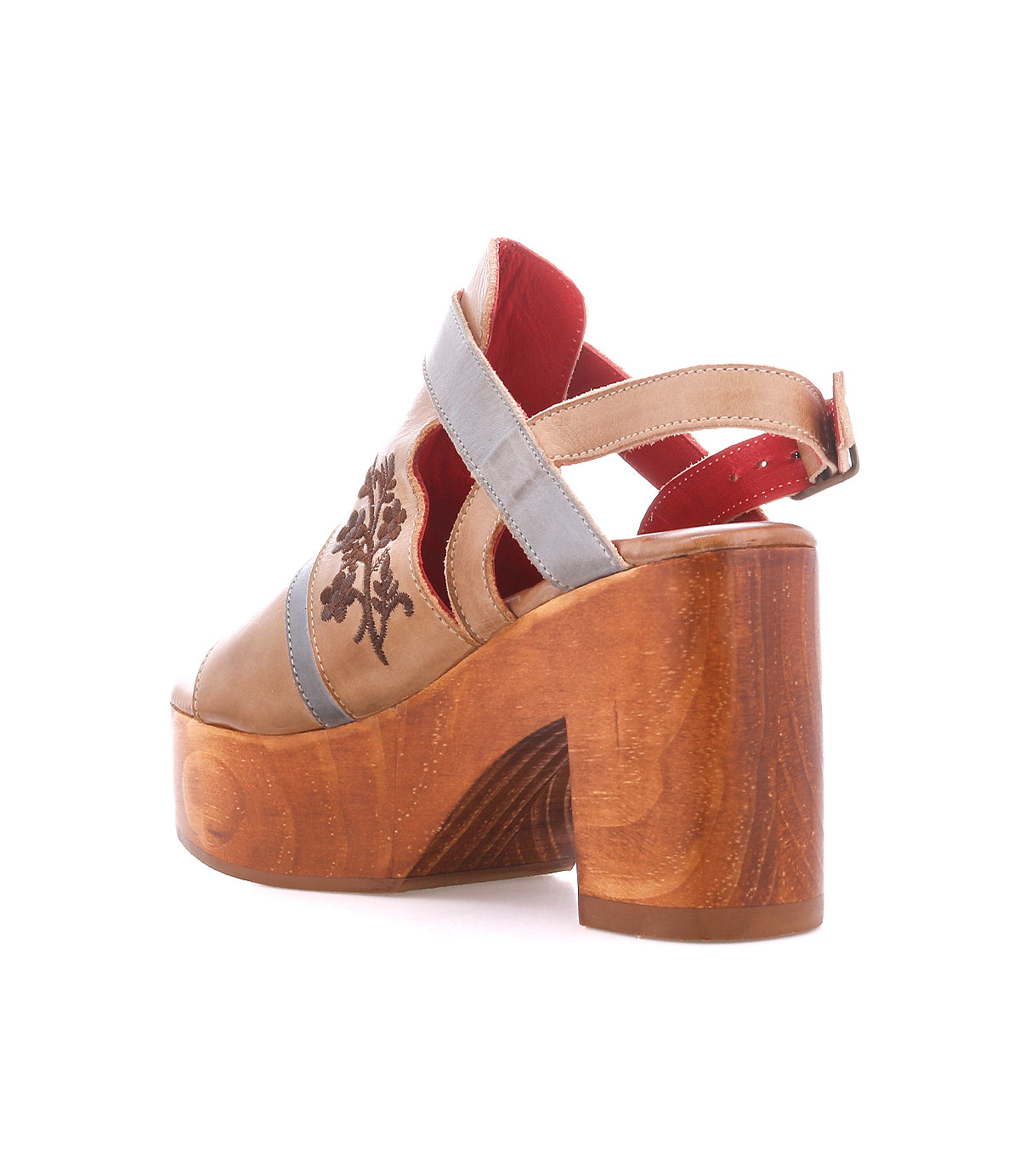 Melodramatic by Bed|Stü: A brown platform sandal featuring a chunky leather heel, blue strap, red interior, and floral embroidery on the side, shown from a rear and angled perspective.