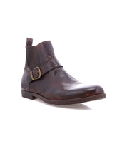 The Bed|Stü Michelangelo is a brown leather ankle boot with a buckle accent and low heel, featuring a durable rubber outsole, shown at a slight angle on a white background.