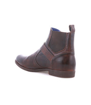 The Bed|Stü Michelangelo is a brown leather Chelsea boot with elastic side panels, a back pull tab, and a low heel, featuring a durable rubber outsole; shown from a rear side angle on a white background.