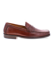 The Moat loafer by Bed|Stü is a handcrafted classic featuring brown leather, detailed stitching, and a low heel, displayed in side profile against a white background.