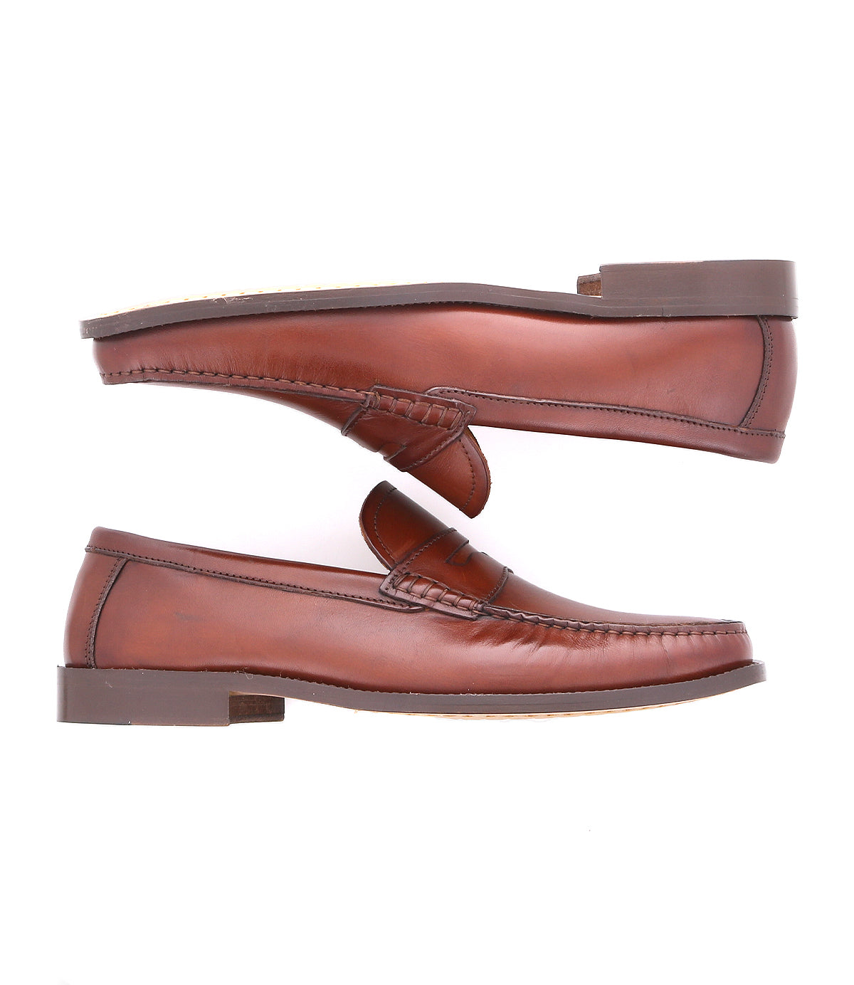 A pair of Bed|Stü Moat handcrafted leather loafers in rich brown are displayed side by side, one facing up and one facing down, against a crisp white background.