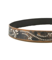The Bed Stu Mohawk is a women's brown distressed leather belt adorned with light floral and dotted patterns etched along its length.