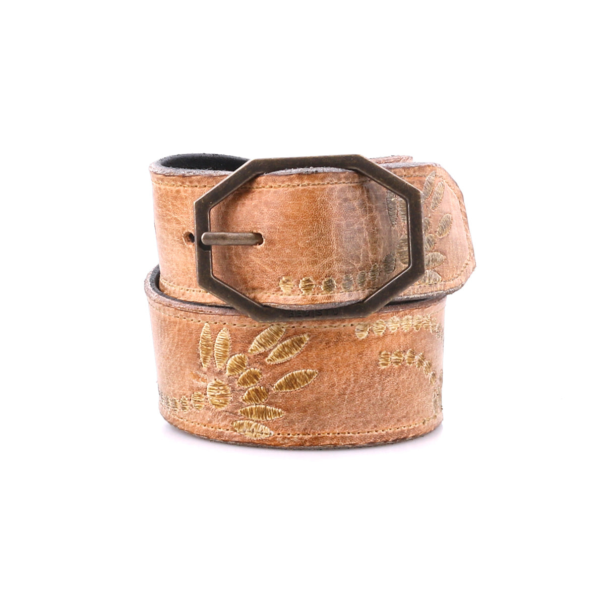 Bed|Stü’s Mohawk belt features rich brown distressed leather, eye-catching floral embroidery, and a distinctive hexagonal metal buckle—rolled up on a white background, it's perfect for adding a touch of western-inspired style to any outfit.