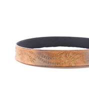 The Mohawk belt by Bed|Stü features brown distressed leather with a black inner lining and elegant yellow floral embroidery in a subtle western-inspired leaf and swirl pattern.