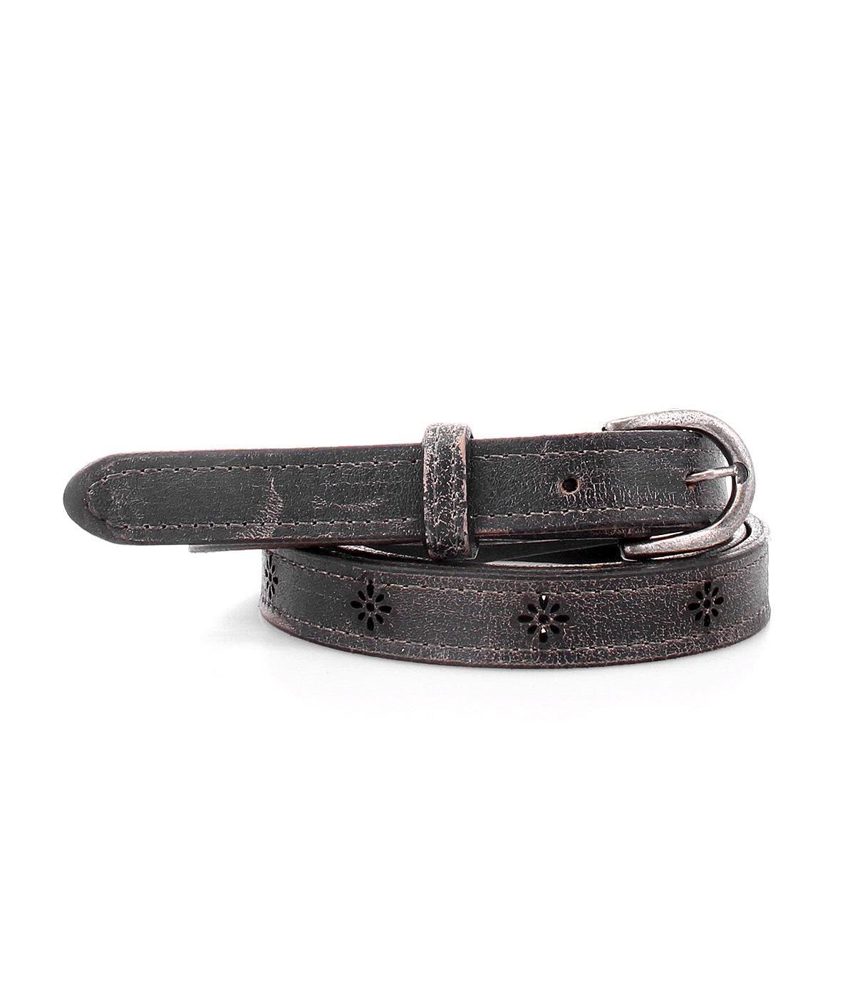 The Monae II by Bed|Stü is a versatile women’s belt featuring black floral cutout designs with small flower-shaped details and a metal buckle, shown coiled on a white background—a perfect accessory for adding a touch of elegance to any outfit.