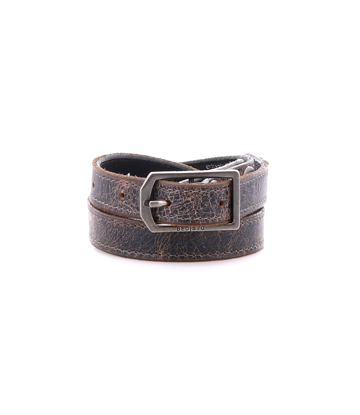 The Monae by Bed|Stü is a slim, brown distressed leather belt featuring a classic silver rectangular buckle, shown rolled up against a plain white background—an essential piece for any everyday wardrobe.
