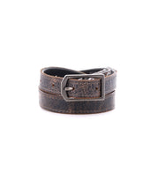 The Monae by Bed|Stü is a slim, brown distressed leather belt featuring a classic silver rectangular buckle, shown rolled up against a plain white background—an essential piece for any everyday wardrobe.