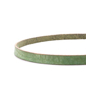 A close-up of the Bed|Stü Monae slim leather belt in green, showcasing its textured leather strap with a suede underside, set against a white background—an essential piece for the everyday wardrobe.
