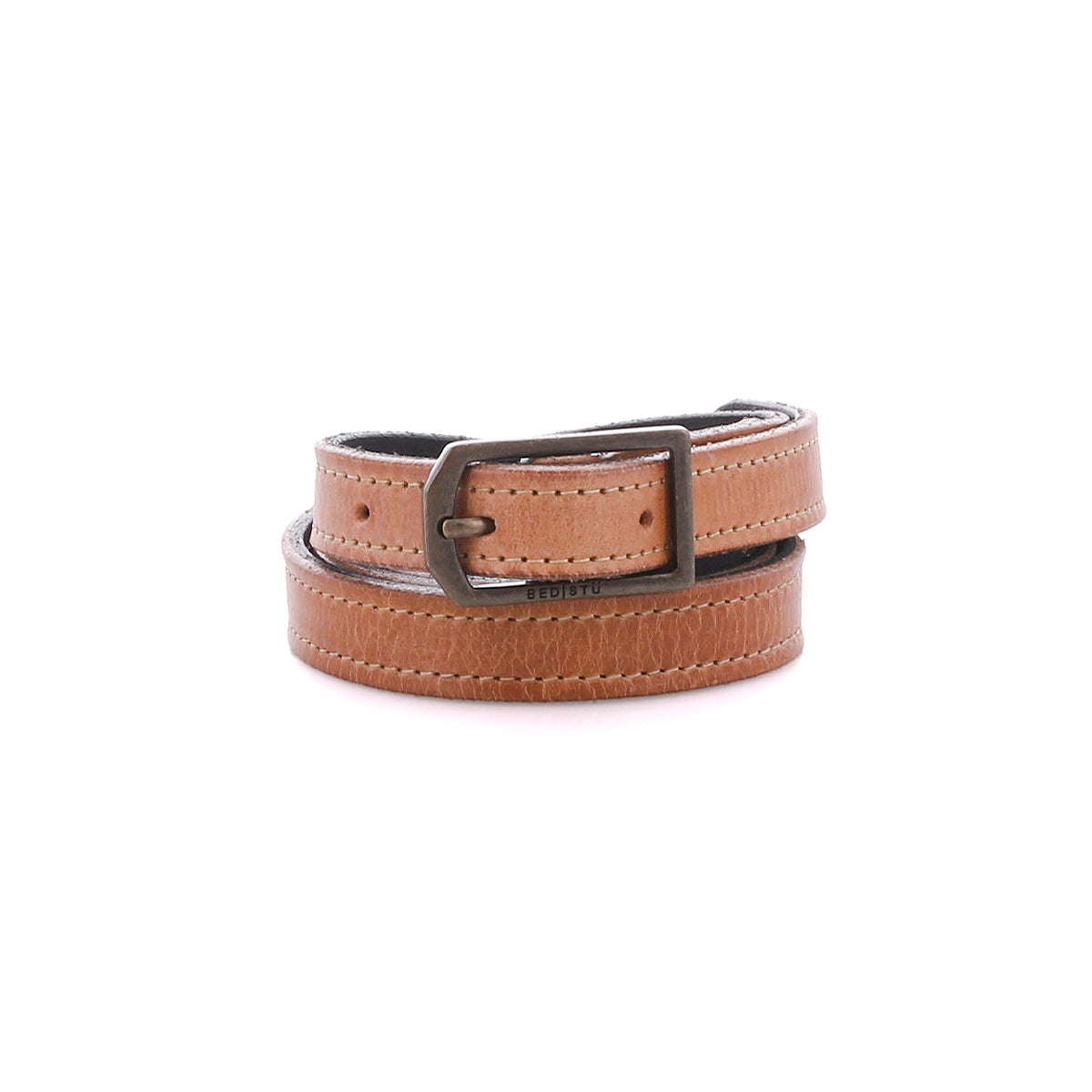The Bed|Stü Monae, a slim light brown leather belt with a rectangular metal buckle, is coiled neatly and displayed on a white background—an ideal versatile accessory for any woman's wardrobe.