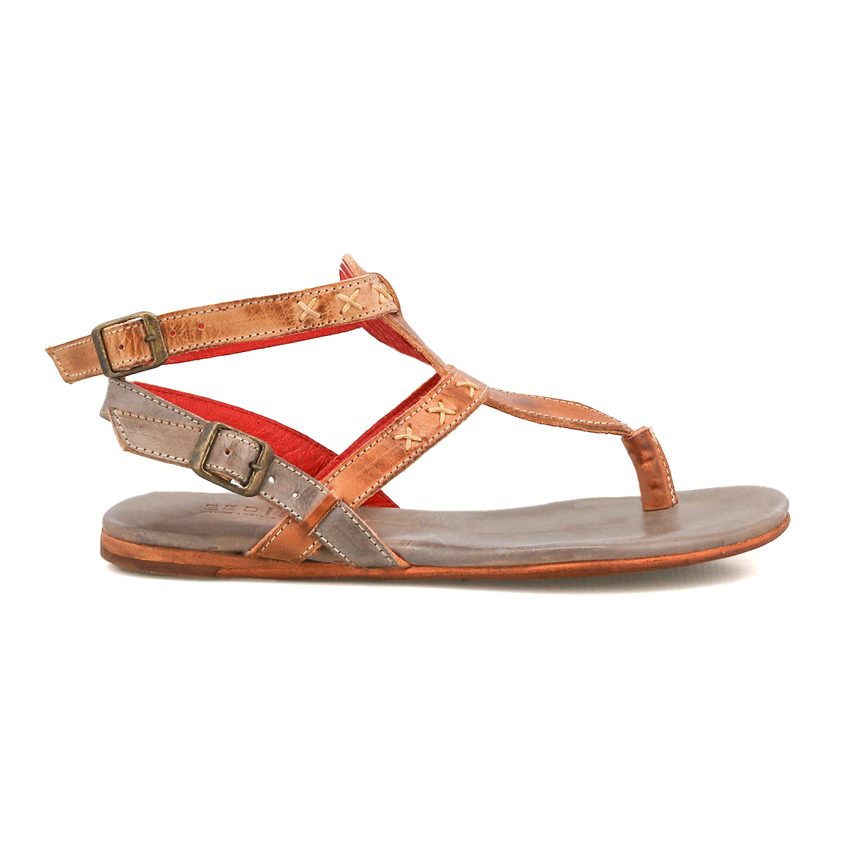 The Bed|Stü Moon sandal is a brown leather flat with two buckled ankle straps, a toe loop, red inner lining, and a cushioned insole for comfort, displayed in side profile against a white background.