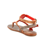 The Bed|Stü Moon sandal is a brown leather flat with an ankle buckle, open toe, and a red interior accent, displayed from a rear side angle on a white background. These stylish sandals also offer a cushioned insole for added comfort.
