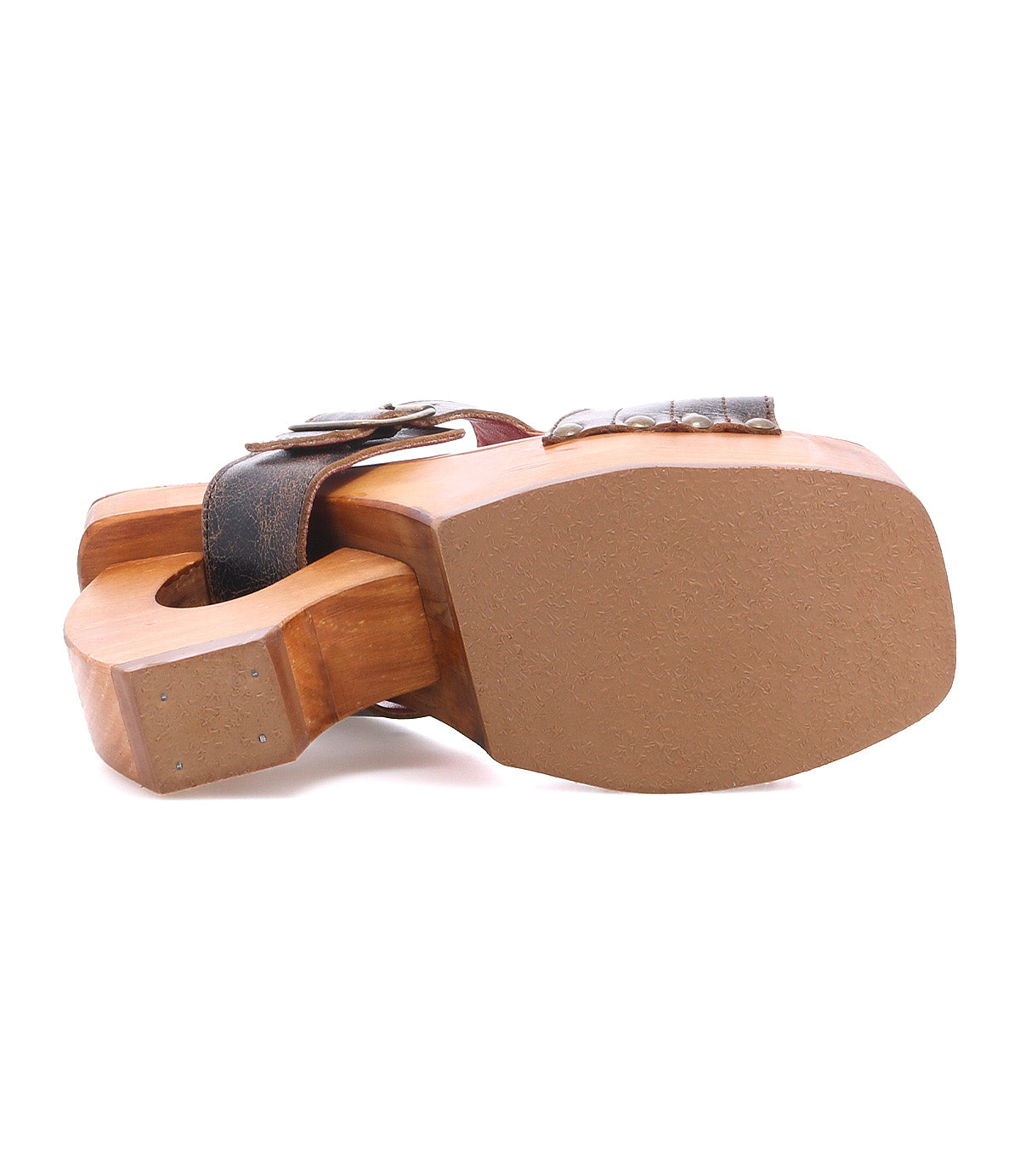 The Mutable sandal by Bed|Stü is a vintage-inspired wooden clog with a thick, flat sole and a dark strap adorned with a decorative buckle, shown here from the bottom.