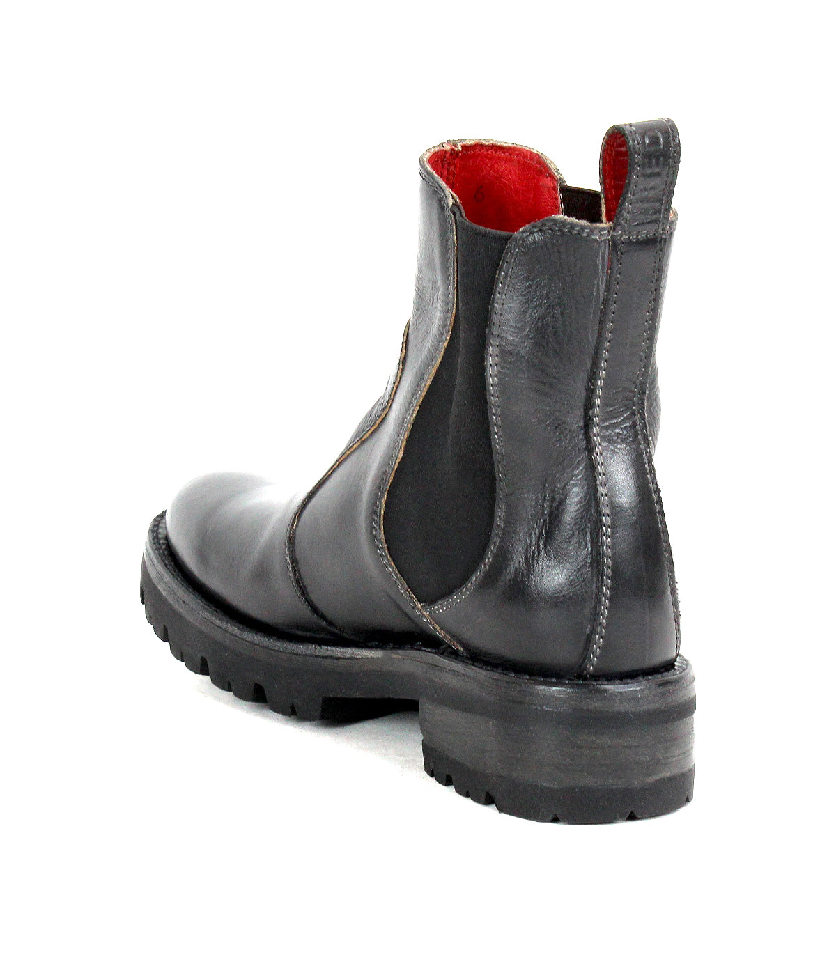 The Bed|Stü Nandi III is a black leather Chelsea boot featuring dual side gores, a rugged sole, and a distinctive red inner lining. Shown from a rear side angle on a white background, this timeless boot combines style and durability.
