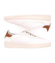Introducing the North by Bed|Stü: a pair of classic men's sneakers in white, featuring cream soles and brown accents on the heel, shown in a side view against a white background.