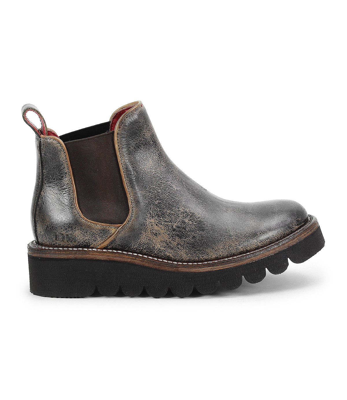 A worn black leather upper Chelsea boot from Bed|Stü, the Novel II features elastic side panels, red lining, a pull tab, and a thick, scalloped platform sole.