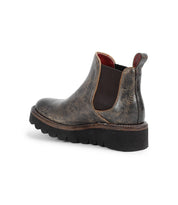 Side view of the Bed|Stü Novel II boot, featuring a dark brown leather upper, chunky black platform sole, elastic side panel, and pull tabs, displayed on a white background.