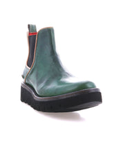 The Bed|Stü Novel II is a green leather Chelsea boot featuring a leather upper, black platform sole, elastic side panel, and pull tab, photographed on a white background.