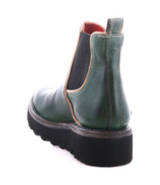 Bed|Stü's Novel II Chelsea boot features a green leather upper, black elastic side panel, tan trim, red lining, and a thick black platform sole, shown here from the back angle.