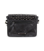 Introducing Occurrence by Bed|Stü: This compact black leather crossbody bag boasts a front zipper pocket, silver studs accentuating the flap, and a sleek metallic Bed|Stü brand plate at the bottom—blending style and function for a versatile clutch that effortlessly elevates any look.
