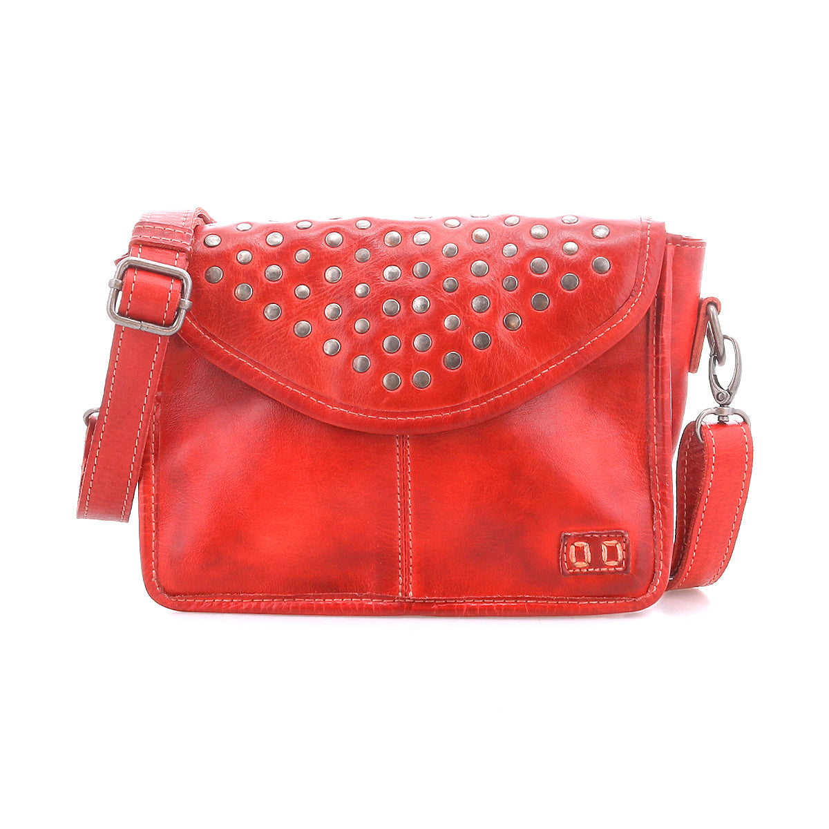 The Bed|Stü Occurrence is a red leather compact crossbody featuring metal studs on the flap, an adjustable strap, and a small stitched logo at the front bottom right corner. This studded bag from Bed|Stü effortlessly blends bold style with everyday practicality.