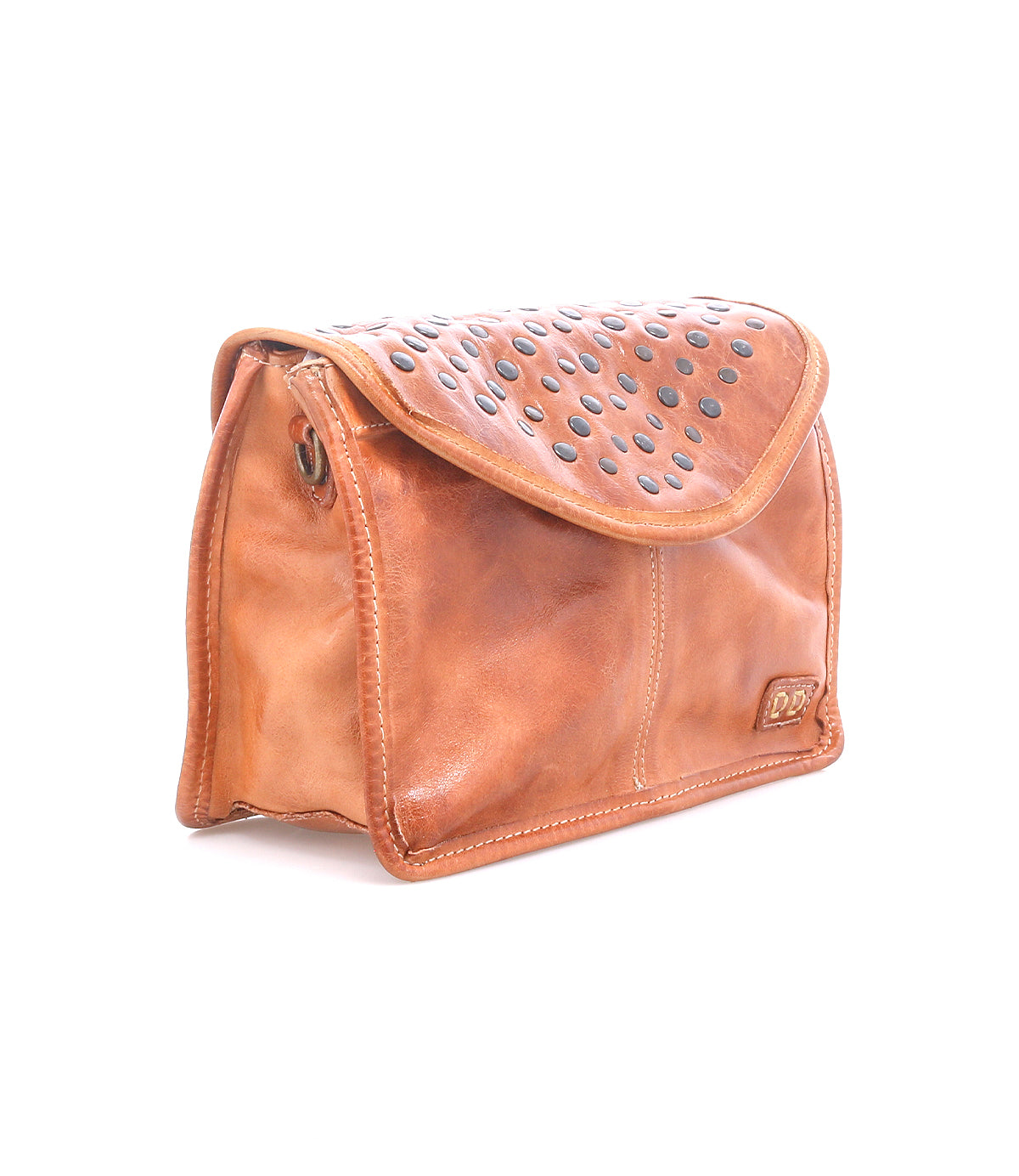 Bed|Stü’s Occurrence is a brown leather studded bag with a flap closure, featuring rows of dark metal studs on the top and shown against a white background. This versatile clutch can also be worn as a compact crossbody, making it perfect for carrying everyday essentials.