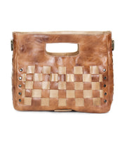 The Orchid by Bed|Stü is a brown leather handbag featuring a checkered handwoven pattern, cutout handle, and decorative metal studs along the sides—a modern, timeless design that brings sophistication to any outfit.