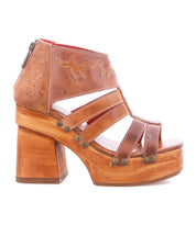 Step into style with the Orphyx by Bed|Stü, a brown leather sandal featuring layered leather straps, an open-toe silhouette, sculpted wood platform sole, block heel, brass stud accents, zippered back closure, and decorative stitching details.