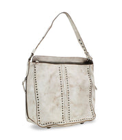 The Packet LTC by Bed|Stü is an off-white leather shoulder tote bag featuring stud detailing, a top zipper closure, and a single handle.