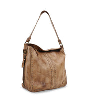 Introducing the Packet LTC by Bed|Stü—a light brown leather shoulder tote featuring a wide strap, decorative stitching, and metal stud accents along the sides and bottom edges.