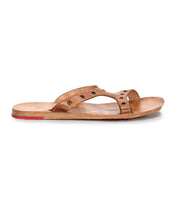 Introducing Path by Bed|Stü: a brown leather slip-on sandal featuring an open toe, metal eyelet accents, and a flat wooden sole with a slim red highlight at the heel. Crafted for effortless everyday wear, this leather sandal is pictured in a side profile view against a white background.
