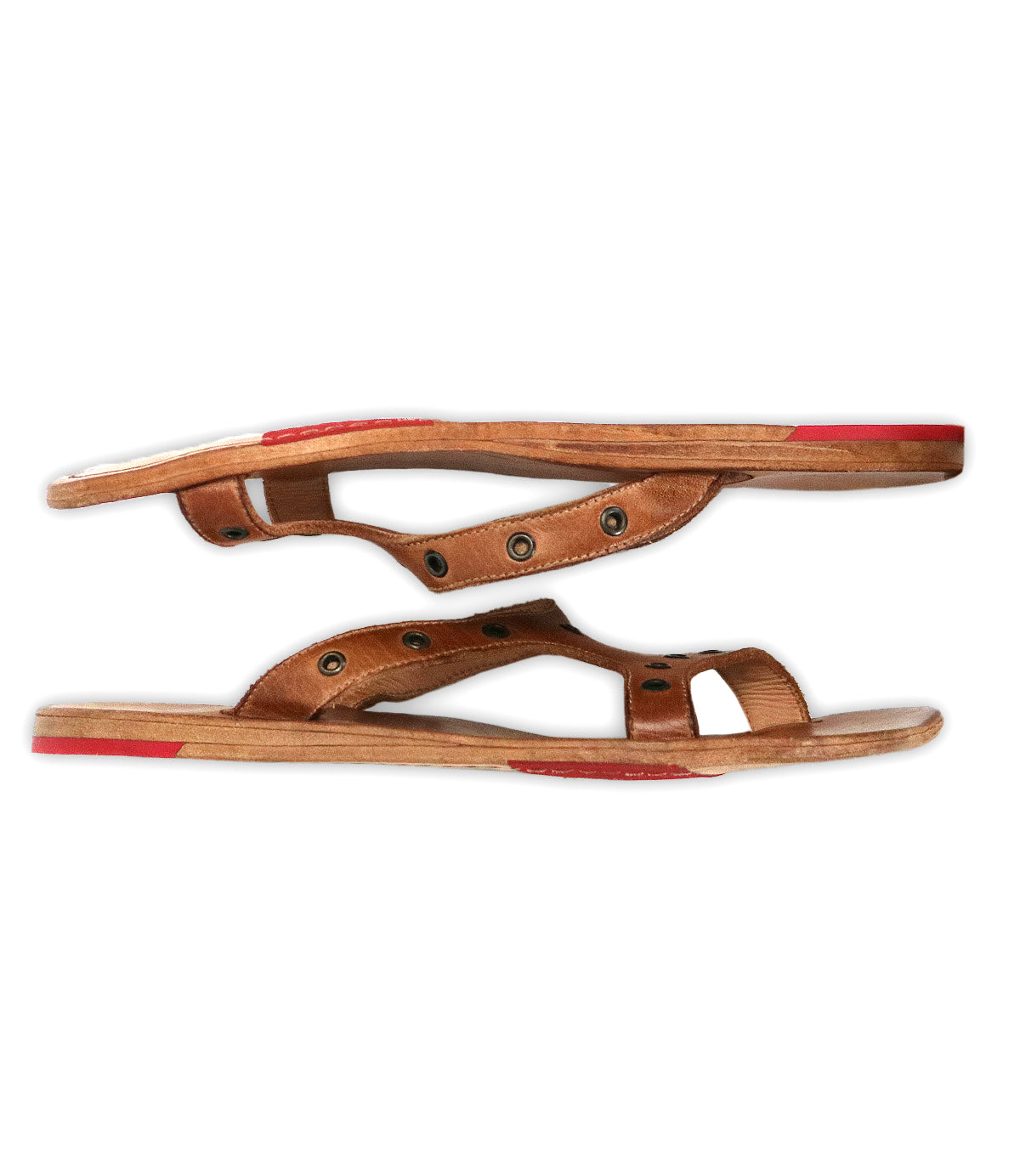 Two Path sandals by Bed|Stü, crafted from brown leather with black rivets and featuring red rubber accents on the toe and heel, are designed as slip-ons for everyday wear and are displayed side by side against a white background.